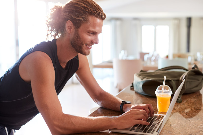 millennial-white-man-checking-fitness-app-on-lapto-9WV83CN.jpg